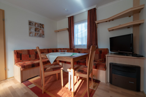Cozy dining corner in glamping accommodation at Camping Hetzingen - Stacaravans Noordrijn-Westfalen, Germany.