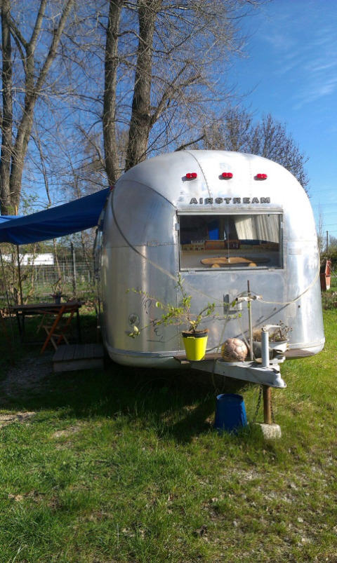 Vintage Airstream Wohnwagen in Thüringen als stilvolles Glamping-Hotel mit einladender Außenumgebung.