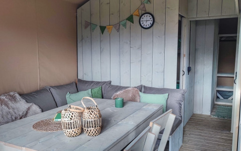 Cozy seating area inside a glamping lodge at Stadslandgoed De Heicohoeve in Gelderland, Netherlands.