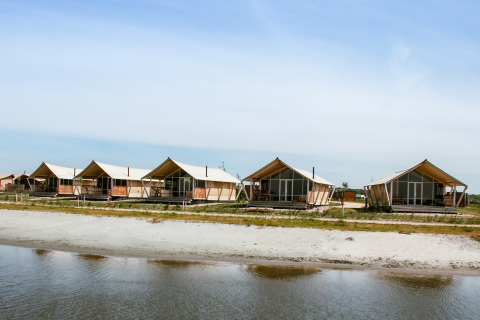 Waterfront glamping accommodation with luxury safari tents at Strandpark De Zeeuwse Kust in Zeeland.