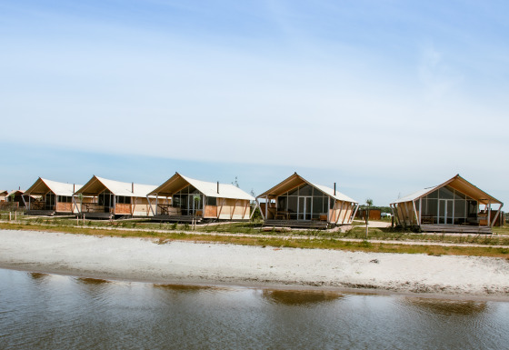 Waterfront glamping accommodation with luxury safari tents at Strandpark De Zeeuwse Kust in Zeeland.