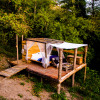 Outdoor glamping accommodation at Novanta Skylodge in Italy, wooden platform nestled in nature.