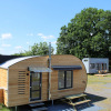 Several modern wooden and colorful tiny houses at the Klein vakantie- en tentoonstellingspark glamping site in Lower Saxony.