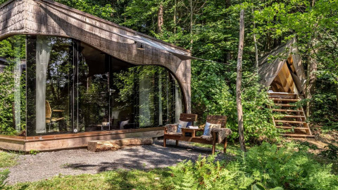 Glamping accommodation at Falkensteiner Premium Camping Blaguš - modern glass cabins in a lush Slovenian forest.