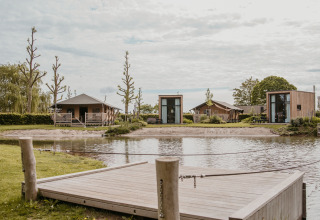 Glamping accommodation with modern cabins and tents by the lake at De Betuwse Hofjes - Ranger Lodges Gelderland.