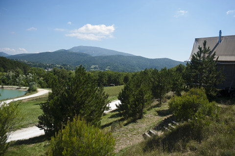 Scenic view of mountains, pines, and glamping tent at Village Huttopia Dieulefit, Drôme-Provence in France.