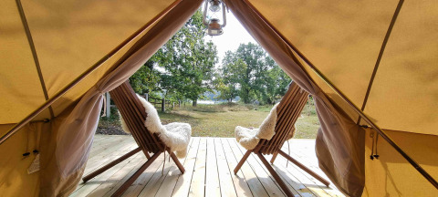 Glamping at Sävö Bed and Breakfast – two cozy chairs on a deck with scenic view in Södermanland, Sweden.