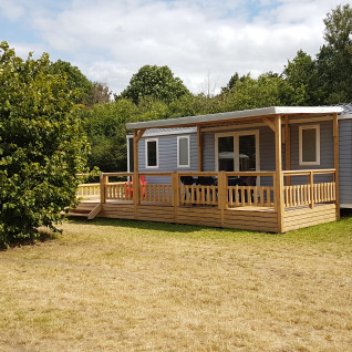 Glamping accommodation with wooden deck and modern cabin at Luxe Camping Borken am See in North Rhine-Westphalia.