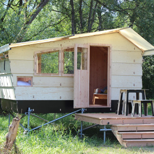 Glamping accommodation 'WERKHAUS destinature - Basic lodge' in Lower Saxony, wooden cabin with small porch.