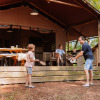 Family having fun outside a glamping lodge at Camping Samoza – Glamping Lodges Veluwe in the forest.