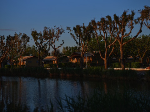 Hébergements glamping au bord du lac à Camping Nautic Almata – Glamping Costa Brava à la tombée du soir.