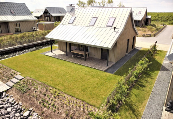 Modernes Ferienhaus Villa Oesterdam Comfort Extra im Oesterdam Resort, Niederlande, mit gepflegtem Garten.