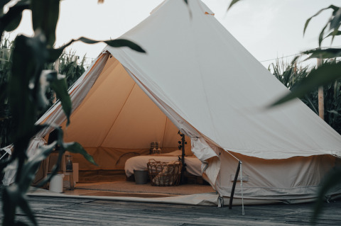 Cozy glamping tent with comfortable interior nestled in nature at Glamping La Ferme, West Flanders, Belgium.