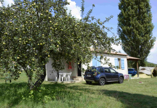 Glamping site Gorges de la Méouge with apple tree, car, tent, and house in Provence-Alpes-Côte d’Azur.
