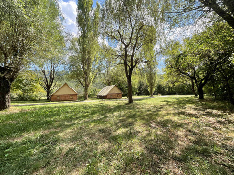 Glamping hut lodges set in a sunny, green landscape at Gorges de la Meouge, Provence-Alpes-Côte d'Azur.