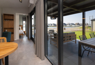 Moderne, luksuriøs glamping lodge i Friese Meren Villa’s, med terrasse, udsigt til natur og vand.