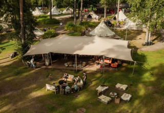 Luchtfoto van Nordic Woods - Wildernis Glamping Zweden met glampingtenten, gezamenlijke ruimte en natuur.