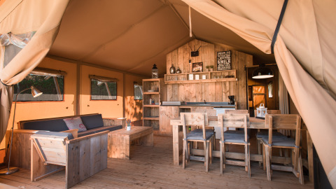 Interieur van glampingaccommodatie bij Quinta do Cascalhal - Safaritenten Braga met houten meubels en warme sfeer.