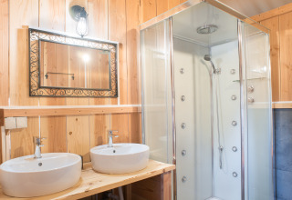 Bagno moderno in legno a Quinta do Cascalhal - Safaritenten Braga con doppi lavandini e cabina doccia.