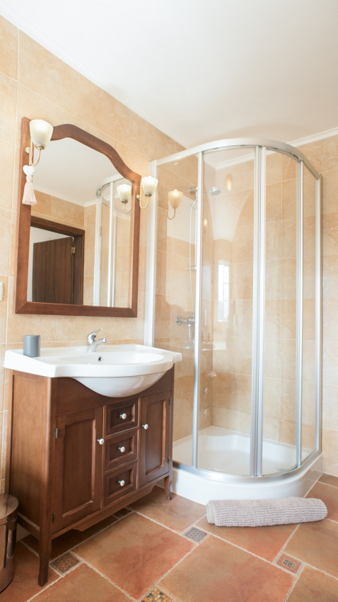 Bathroom with shower, sink, and wooden vanity at Quinta do Cascalhal - Safaritenten Braga glamping site.