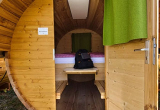 Entrance to a cozy, barrel-shaped glamping pod at Camping Markelfingen by Lake Constance.