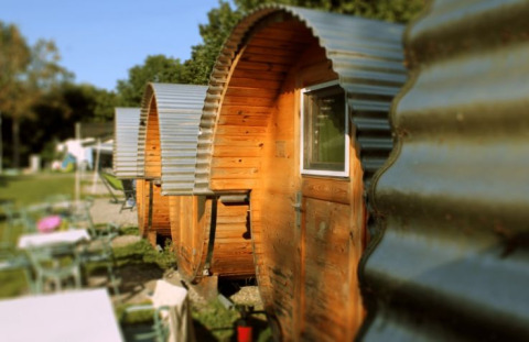 Rij glamping vaten bij Camping Markelfingen Schlaffässer aan de Bodensee met zicht op het buitenterrein.