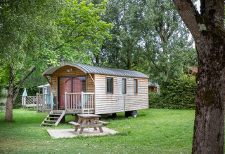 Glamping accommodation at Huttopia La Plage Blanche, Franche-Comté, a cozy wooden cabin in nature.