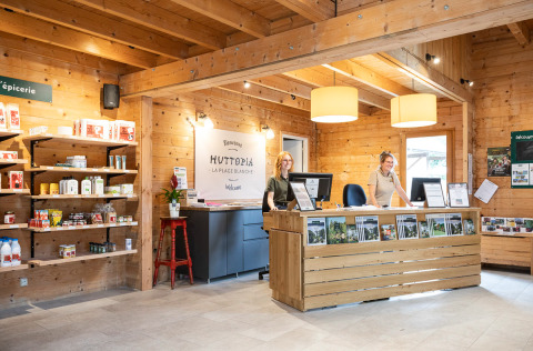 Reception of Huttopia La Plage Blanche - Glamping Franche-Comté with friendly staff and a small shop area.