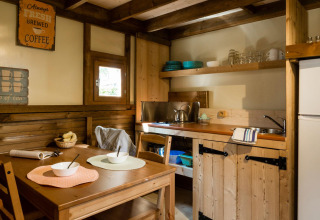 Cozy wooden kitchen and dining area at Lago Idro Glamping Boutique in Lombardy, Italy.