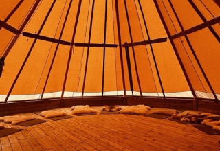 Intérieur d’un dôme glamping à Brokkestøylen - Domes in Agder avec plancher en bois et assises confortables.
