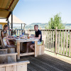 Family enjoying breakfast together on the wooden terrace at Villa la Diva - Safaritenten Le Marche.