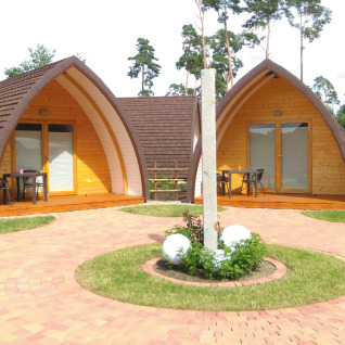 Glamping accommodatie bij Campingpark Buntspecht in Brandenburg met moderne houten pods en terrassen buiten.