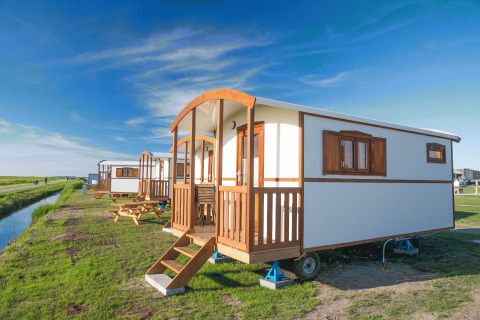 Glamping accommodation at Campingplatz am Nordseestrand with gypsy wagons in scenic Oost-Friesland