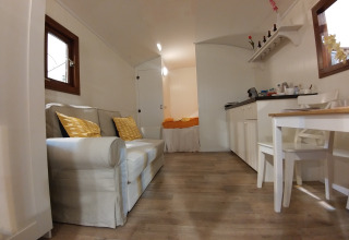 Interior of glamping accommodation at Campingplatz am Nordseestrand - Zigeunerwagen Oost-Friesland, cozy decor.