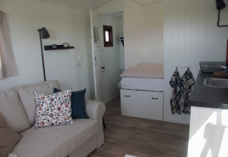 Intérieur d’un hébergement cosy au Campingplatz am Nordseestrand - Zigeunerwagen Oost-Friesland aux Pays-Bas.