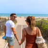 Couple walking to the beach holding hands at Camping Beauregard Plage - Glamping Languedoc-Roussillon.
