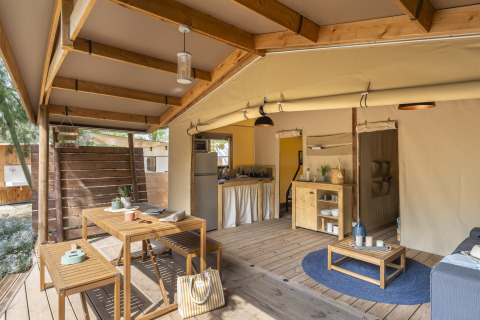 Interior of glamping accommodation at Camping Beauregard Plage with wooden furniture and cozy decor.