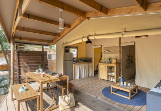 Indendørs glamping indkvartering i Camping Beauregard Plage med træmøbler og skandinavisk design.