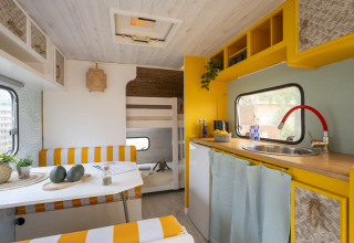 Modern glamping accommodation at Camping Beauregard Plage, Languedoc-Roussillon, with bright kitchen and seating.
