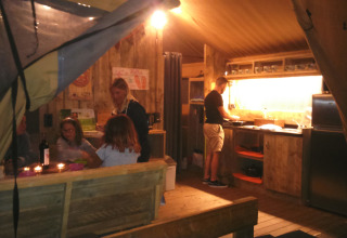 Familie geniet van koken en samenzijn in safaritent bij Camping Lloret Blau, Costa Brava.