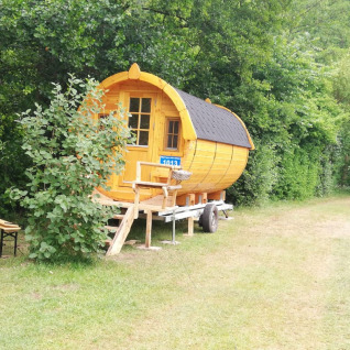 Glamping accommodation at Camping Hetzingen - Wijnvaten North Rhine-Westphalia, surrounded by forest.