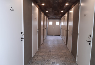 Hallway in Minicamping Sint Jan with white safari tent doors named Zee and Zon, Zeeland, Netherlands.