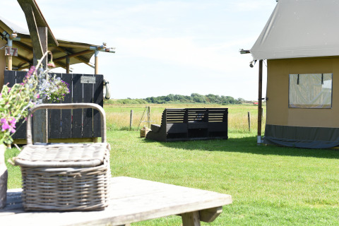Glamping accommodation at Duynpark Het Zwanenwater - Woodlodges Noord-Holland with meadow views.