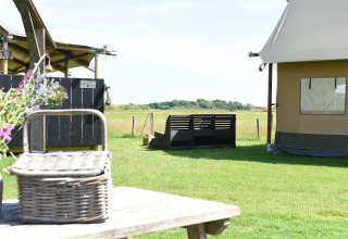 Glamping accommodation at Duynpark Het Zwanenwater - Woodlodges Noord-Holland with meadow views.