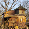Unique treehouse glamping accommodation at Dierentuin Schwerin, featuring rustic wooden architecture.
