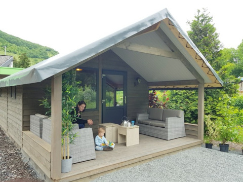 Glamping accommodation at Camping Alf - Chalets Rhineland-Palatinate, cozy porch with outdoor seating.