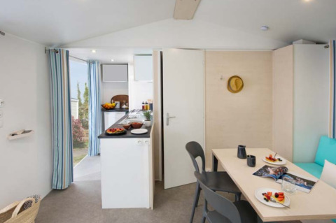 Moderne glamping accommodatie bij Camping Alf - Chalets Rijnland-Palts met keuken, eethoek en buitenzicht.