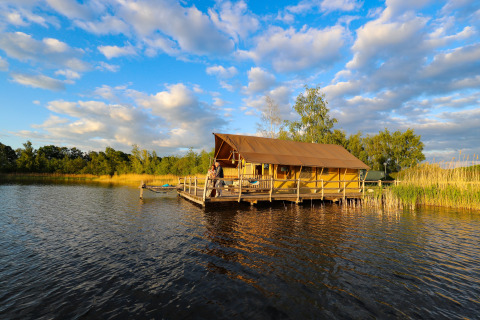 Glamping-accommodatie op het water bij Recreatiepark TerSpegelt - WaterLodges Brabant omgeven door natuur.