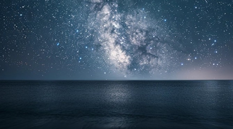 Starry night sky over the sea, viewed from Lavita Camp Cagliari glamping tents in Sardinia.