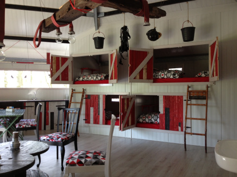 Unique glamping bunk beds in a farmhouse-style interior at De Vreemde Vogel in Zuid-Holland, Netherlands.